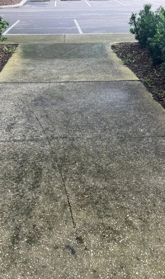 Stained sidewalk before pressure washing
